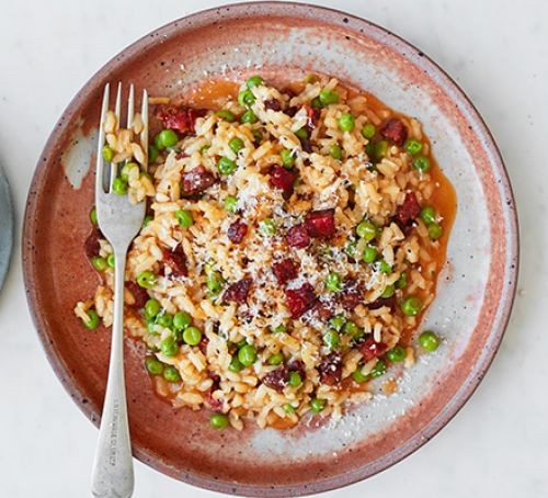 Chorizo and pea risotto served on a plate
