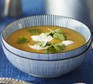 Curried lentil, parsnip & apple soup topped with herbs and yogurt
