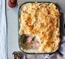 Easy-to-scale cheesy fish pie with kale served in a casserole dish