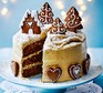 Gingerbread cake covered with caramel biscuit icing and topped with iced gingerbread biscuits