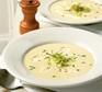 Leek & potato soup garnished with chives, buttered leeks & cream