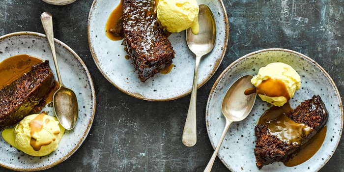 Slow cooker sticky toffee pudding on plates with ice cream