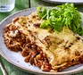 Vegan lasagne on a plate with a green salad